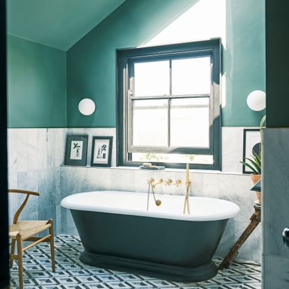blue bathroom with large window and bath