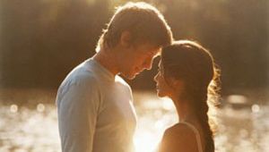 couple holding hands by a lake