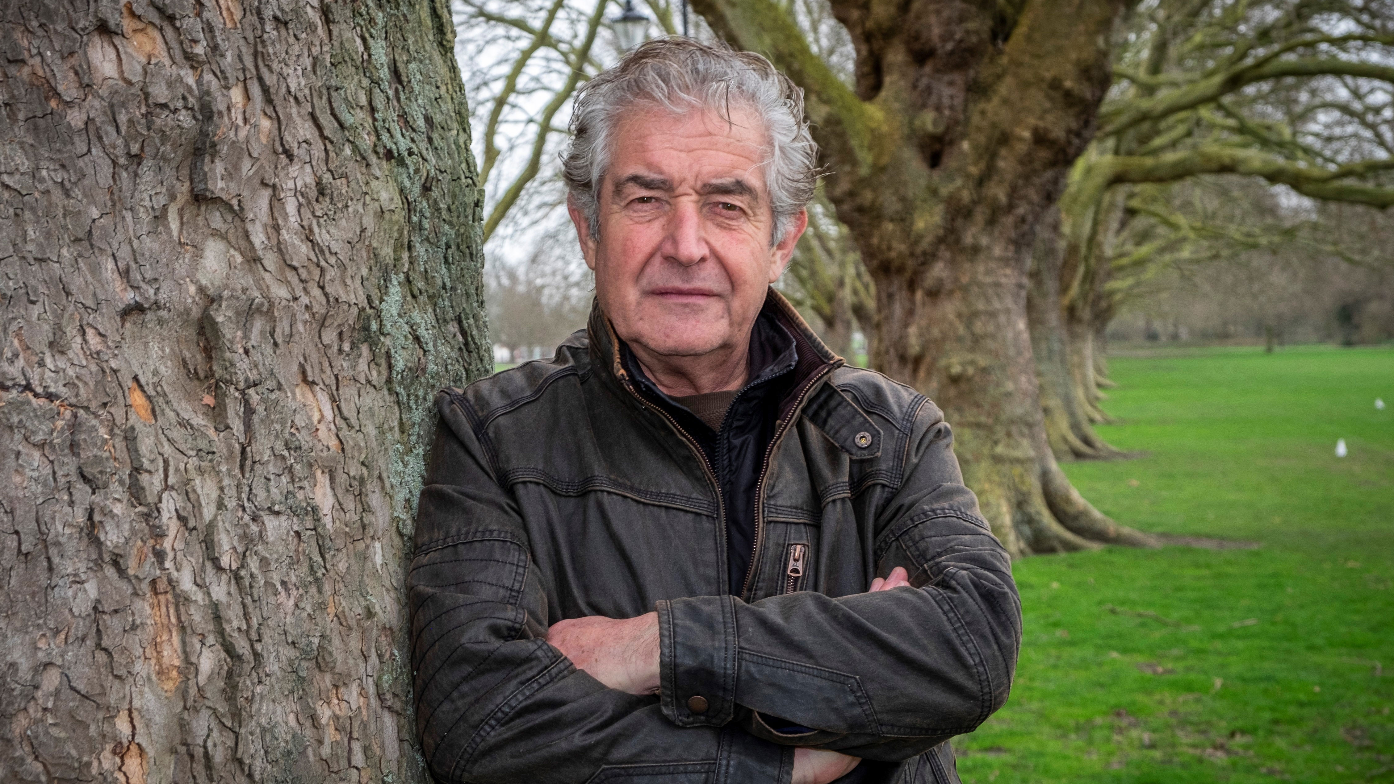Man standing next to tree