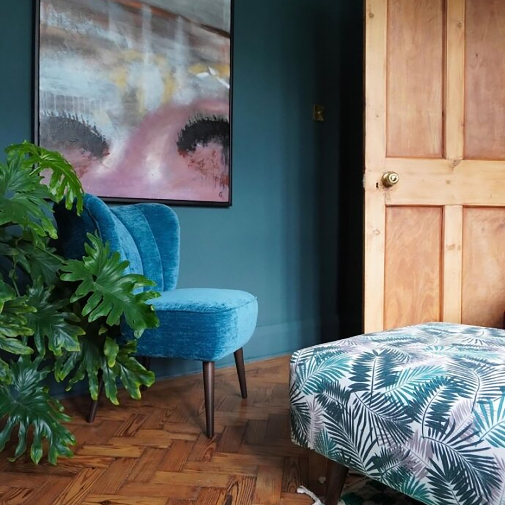 Living room with blue wall and matching blue armchair