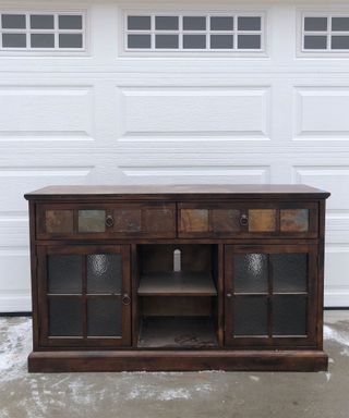 Wooden cabinet in front of white garage