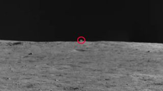 The 'mysterious hut' appears as a cube-shaped protuberance above the horizon of the lunar surface.