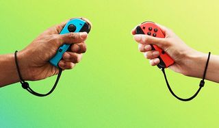 hands holding Switch joycon controllers