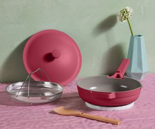 Always Pan 2.0 in raspberry on a pink counter against a sage green wall.