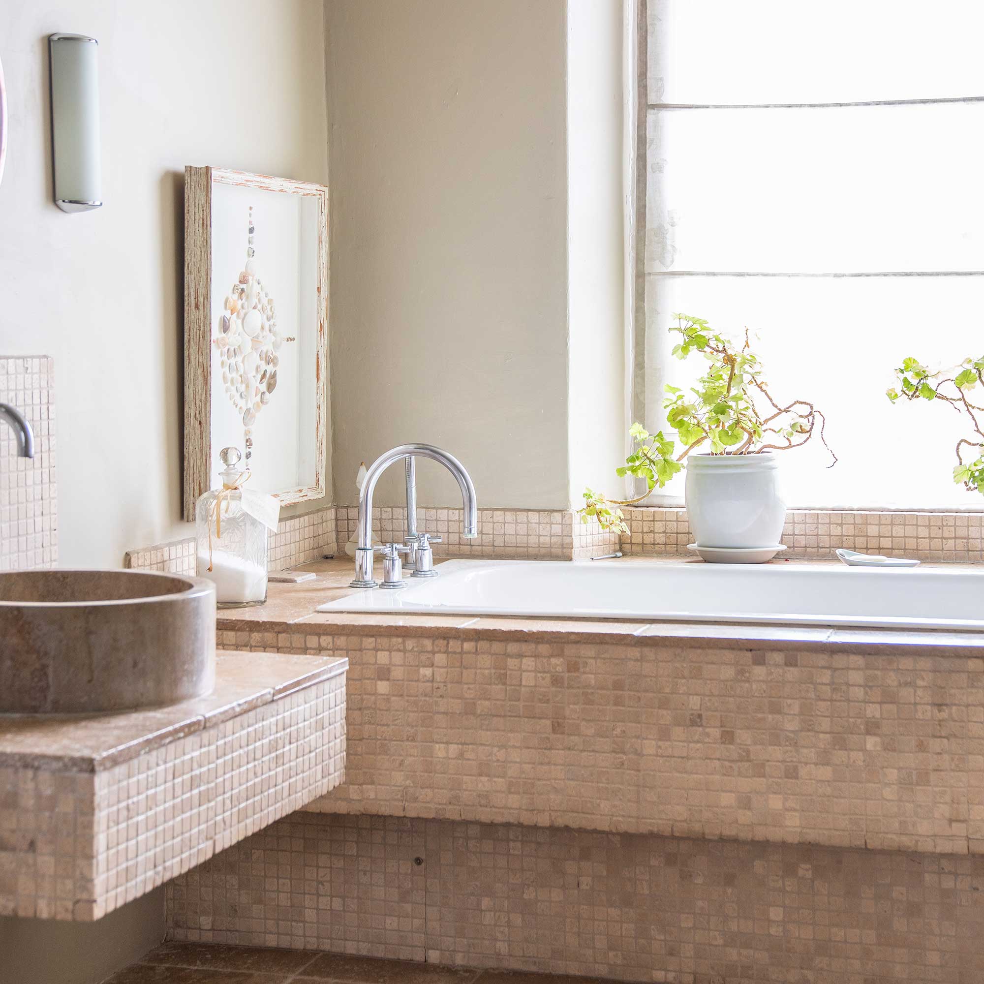 bathroom with mosaic tiles bath surround and basin stand