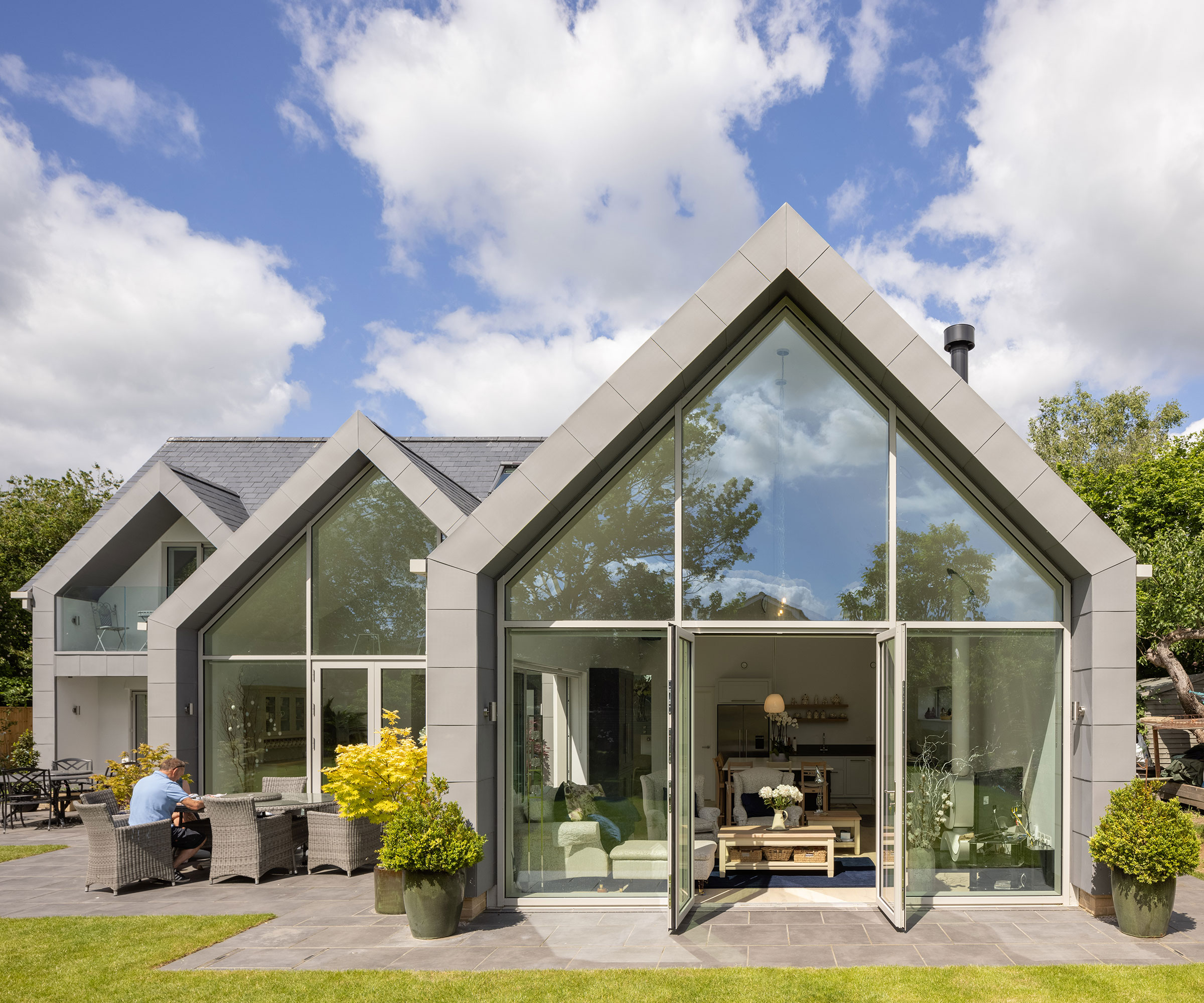 modern triple gabled house with oversized French doors