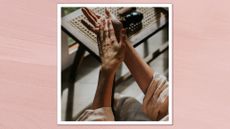 A close up of a woman rubbing hand/body cream into her hands and arms/ in pink template 