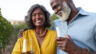 Couple at vineyard enjoying wine tasting