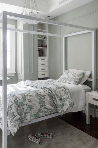 Pale green girls bedroom with four poster bed