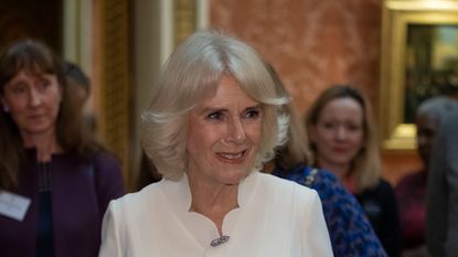 Queen Camilla glows in white scalloped dress at Buckingham Palace 