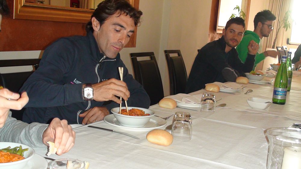 Manuele Mori digs into dinner at the Project TJ Sport team camp.