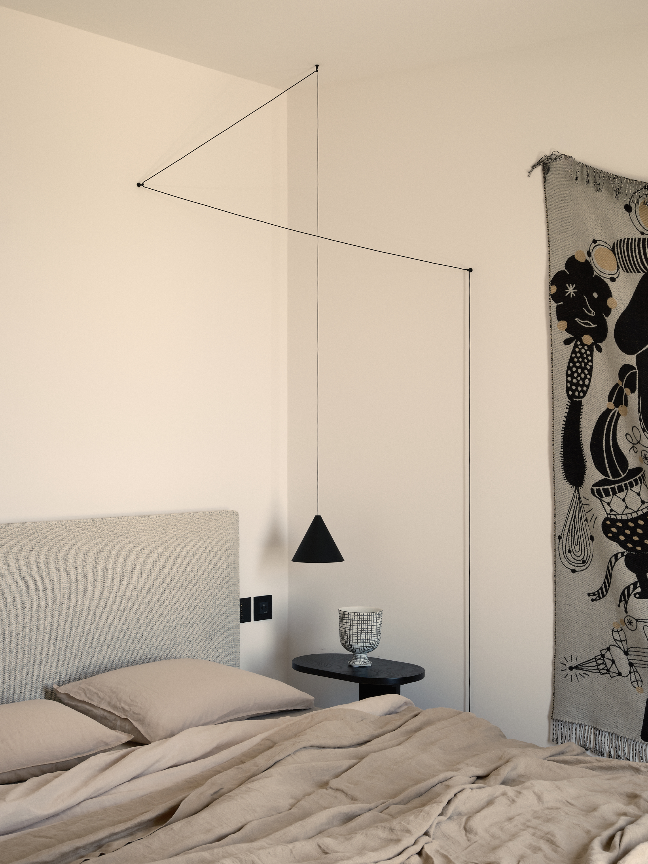 neutral bedroom with Flos pendant light