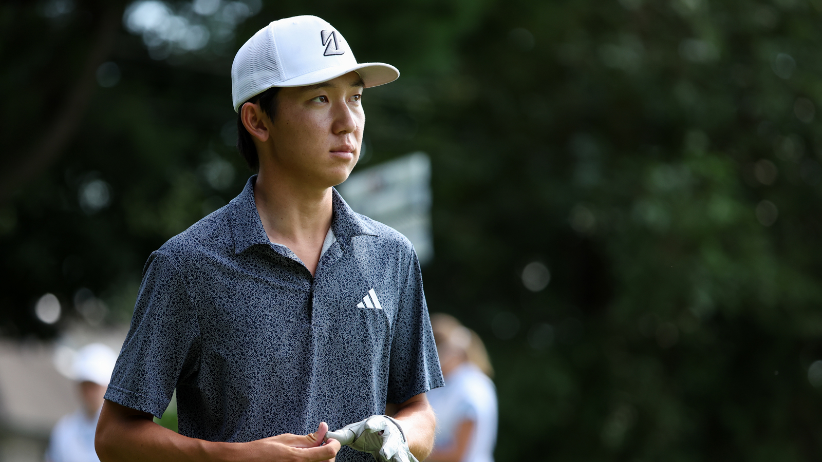 Jay Leng Jr walks off the green taking his glove off