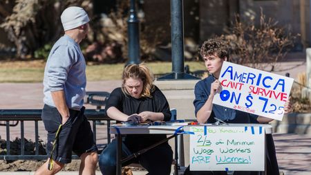 picture of people collecting signatures for a petition to raise the minimum wage