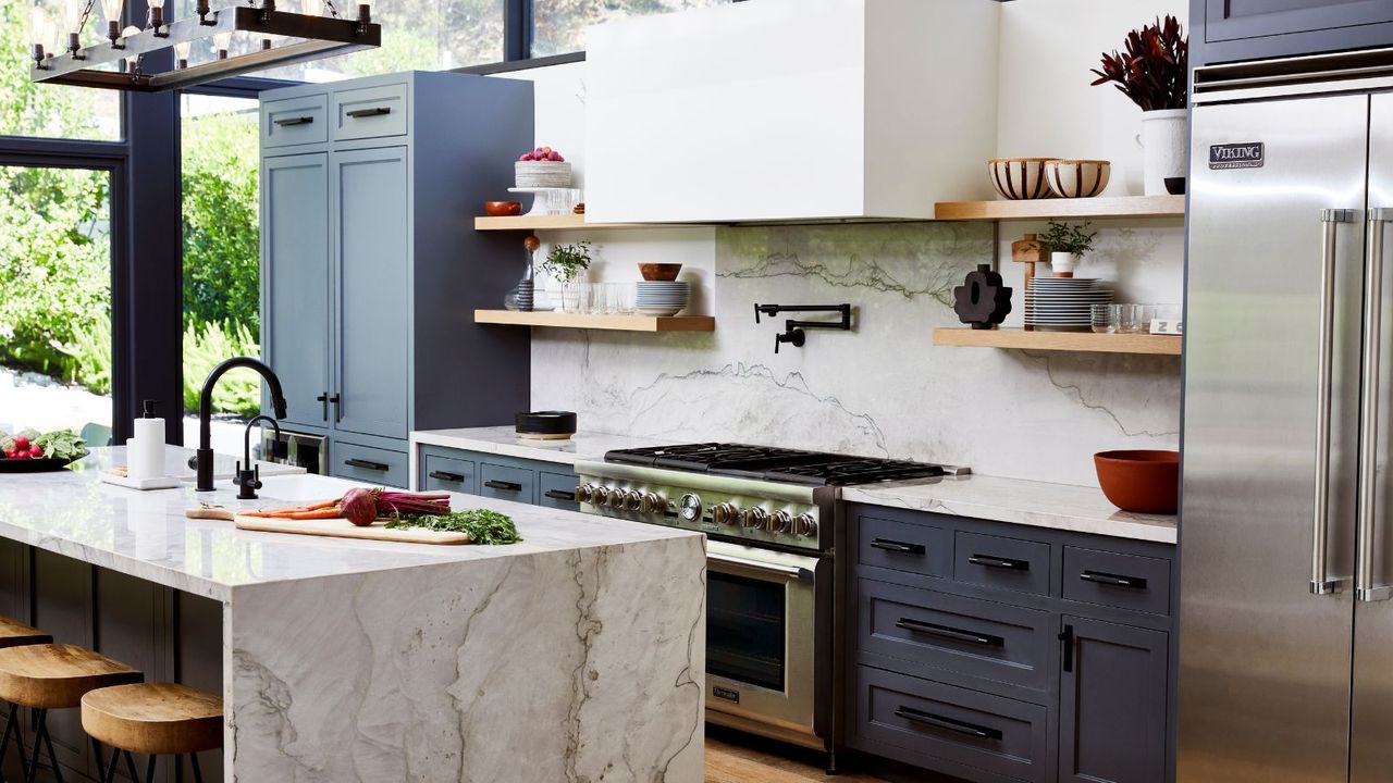 Kitchen with full height glazing blue cabinets marble island and backsplash