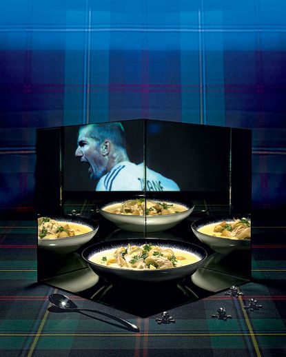 Plate of food sat in mirrored glass reflecting a TV