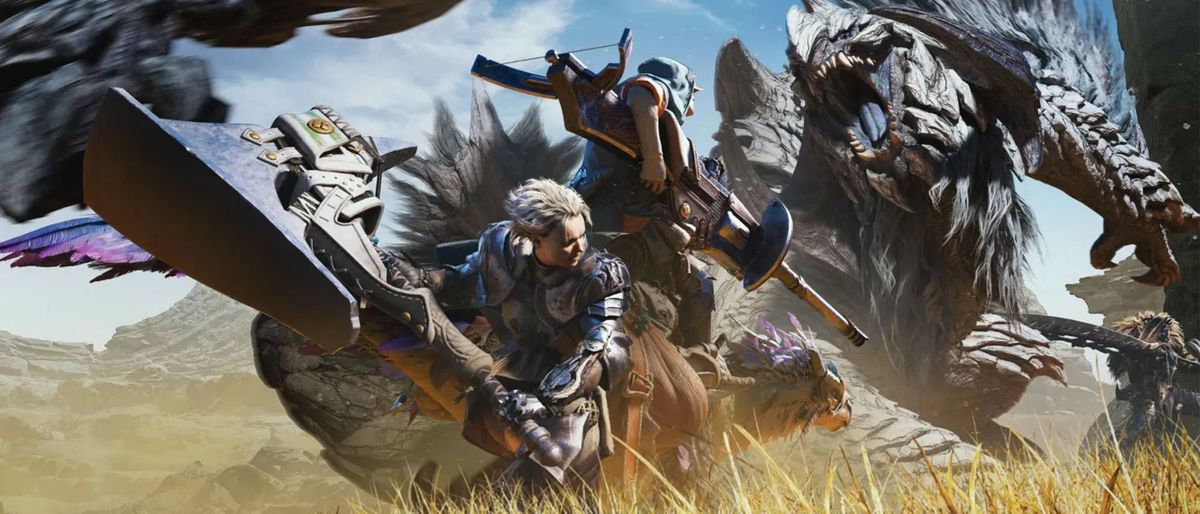 Monster Hunter Wilds review; A promotional image for the video game &quot;Monster Hunter Worlds&quot; depicts two monster hunters mounted on creatures, engaged in a battle against a large, formidable monster in a vast, arid landscape.