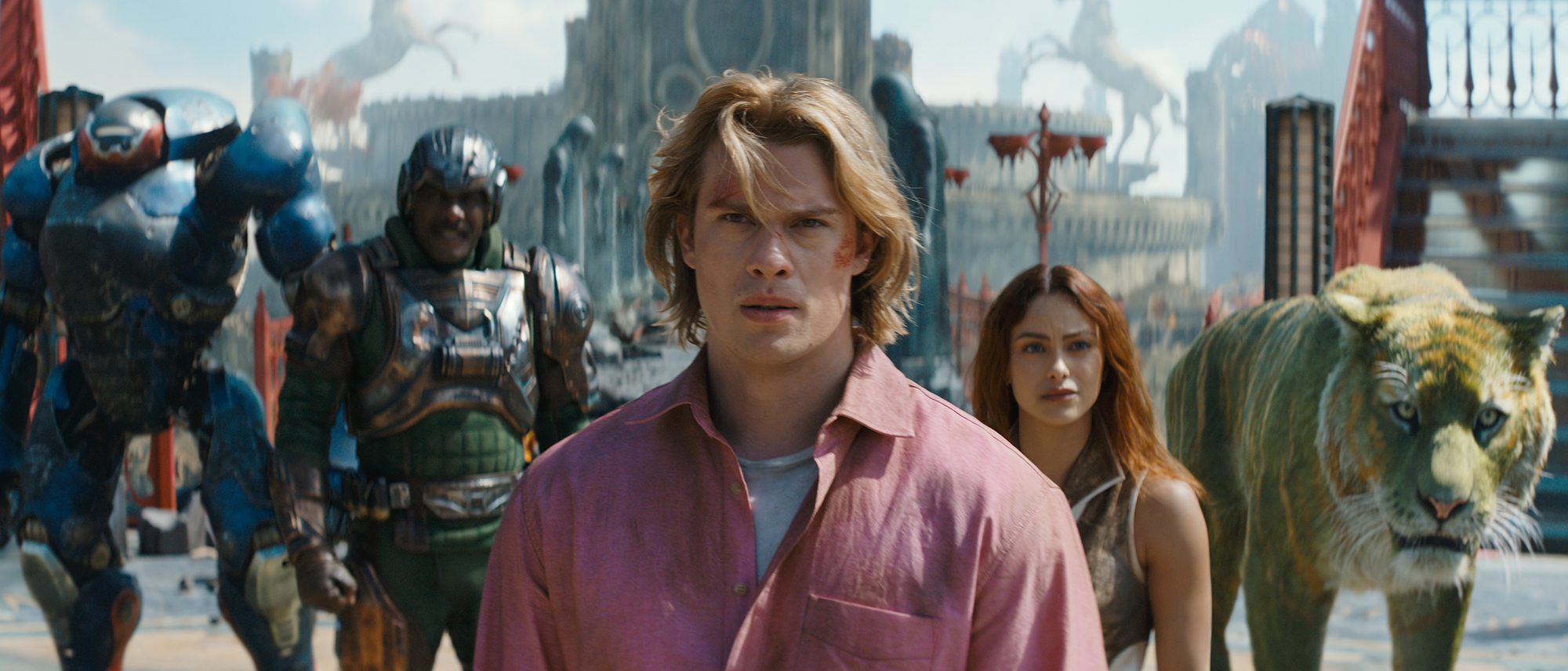 Roboto, Duncan/Man-at-Arms, Adam, Teela, and Cringer standing on a stone bridge in 2026's Masters of the Universe movie