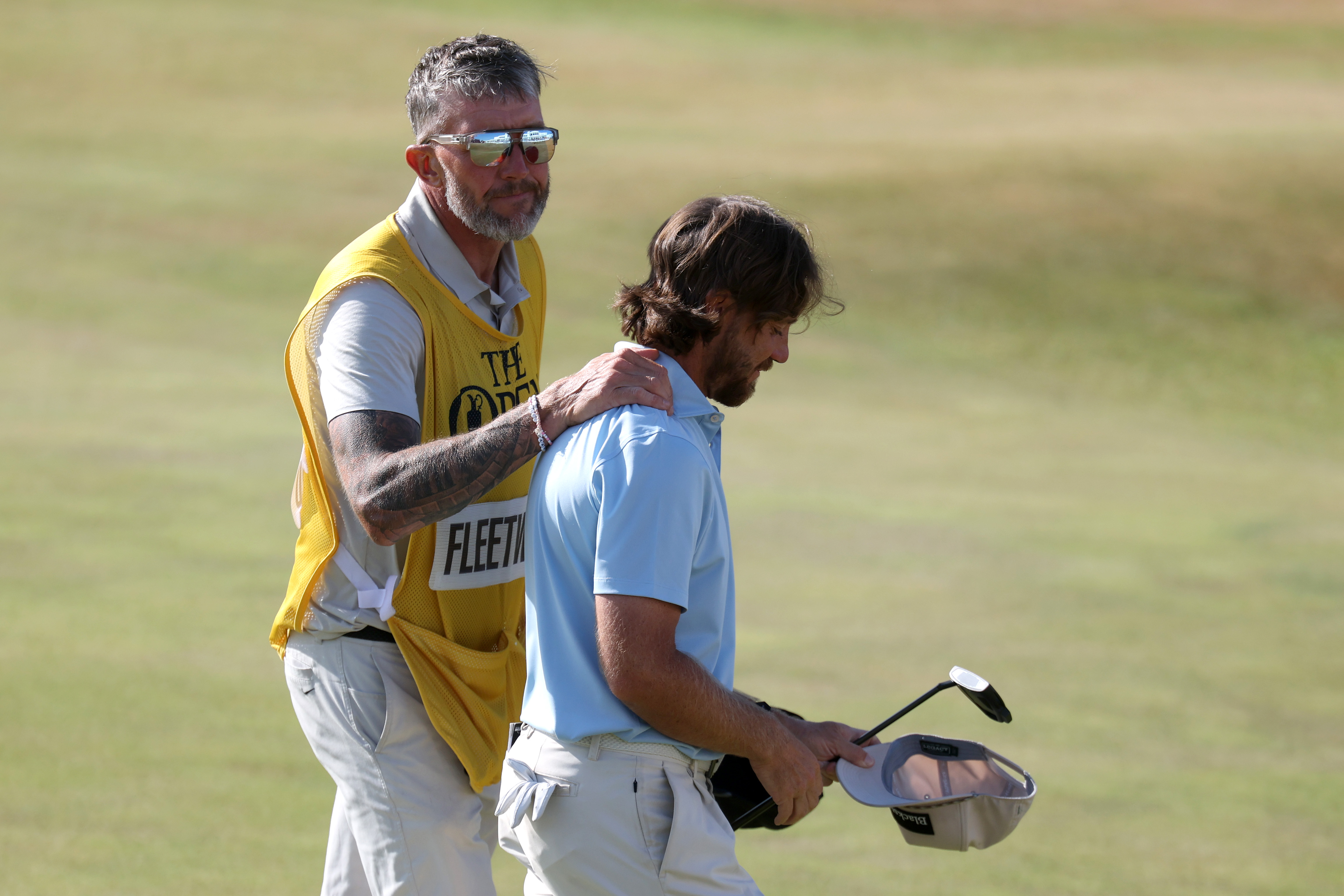 Tommy Fleetwood is congratulated by his caddie Ian Finnis following a T4th finish at The Open in 2026