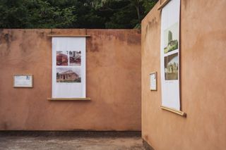 exhibition at palais de lome, exterior view with pink hued walls