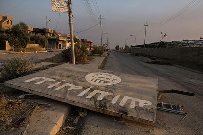 A destroyed ISIS billboard.