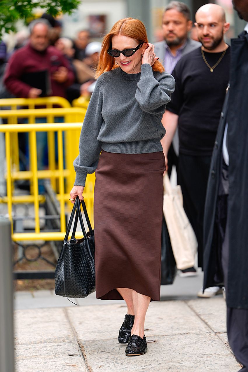 Julianne Moore wearing a gray sweater, brown skirt, and braided Bottega Veneta flats in NYC