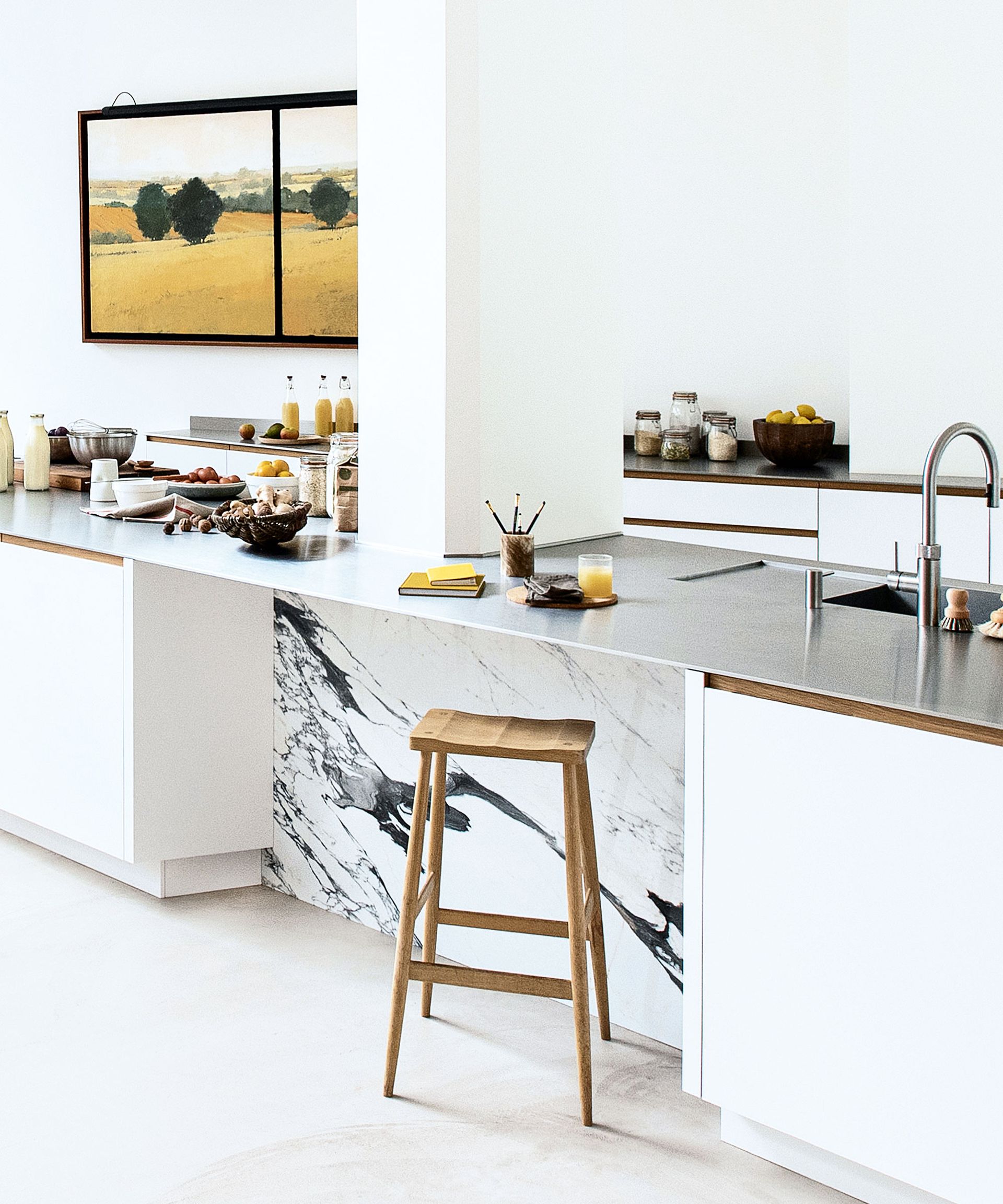White kitchen with white island, cabinetry and stools