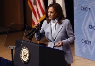 Kamala Harris speaking at her event in a powder blue suit