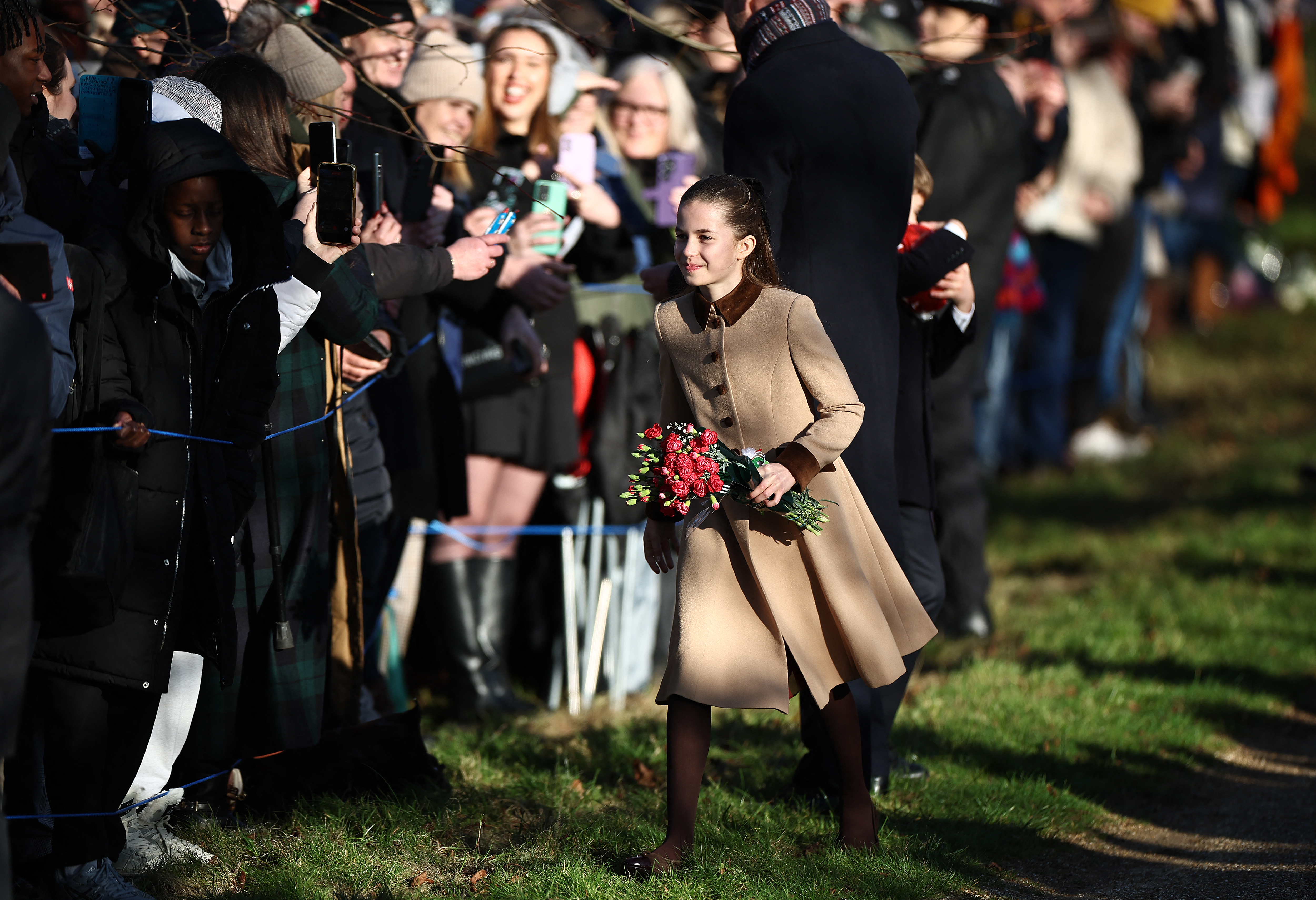 Princess Charlotte walking with flowers on Christmas day 2025
