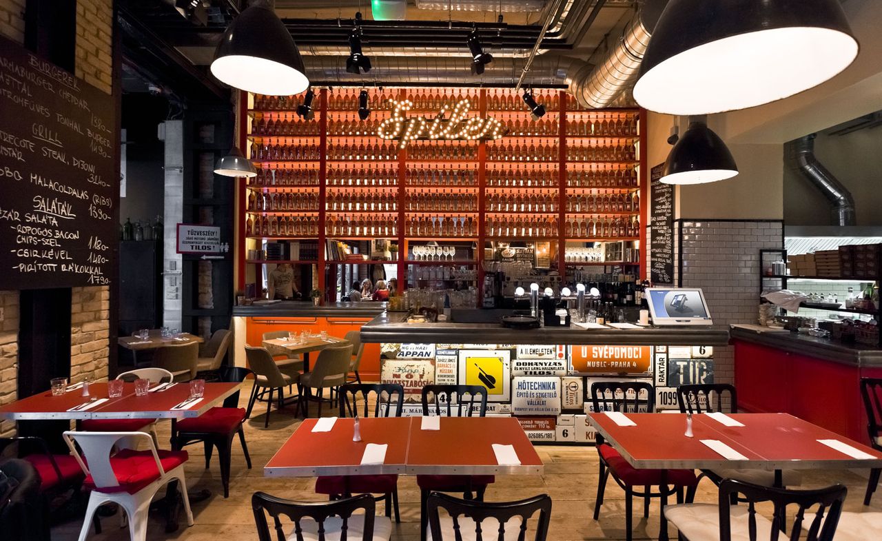 Bar and dining area featuring old road and street signs, exposed brickwork and industrial-style lighting