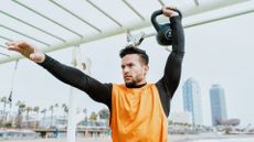 Man exercising with a kettlebell outside