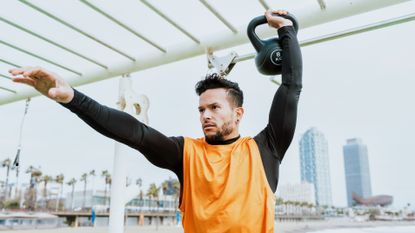 Man exercising with a kettlebell outside