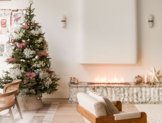 a modern fireplace dressed with a christmas tree and decorations