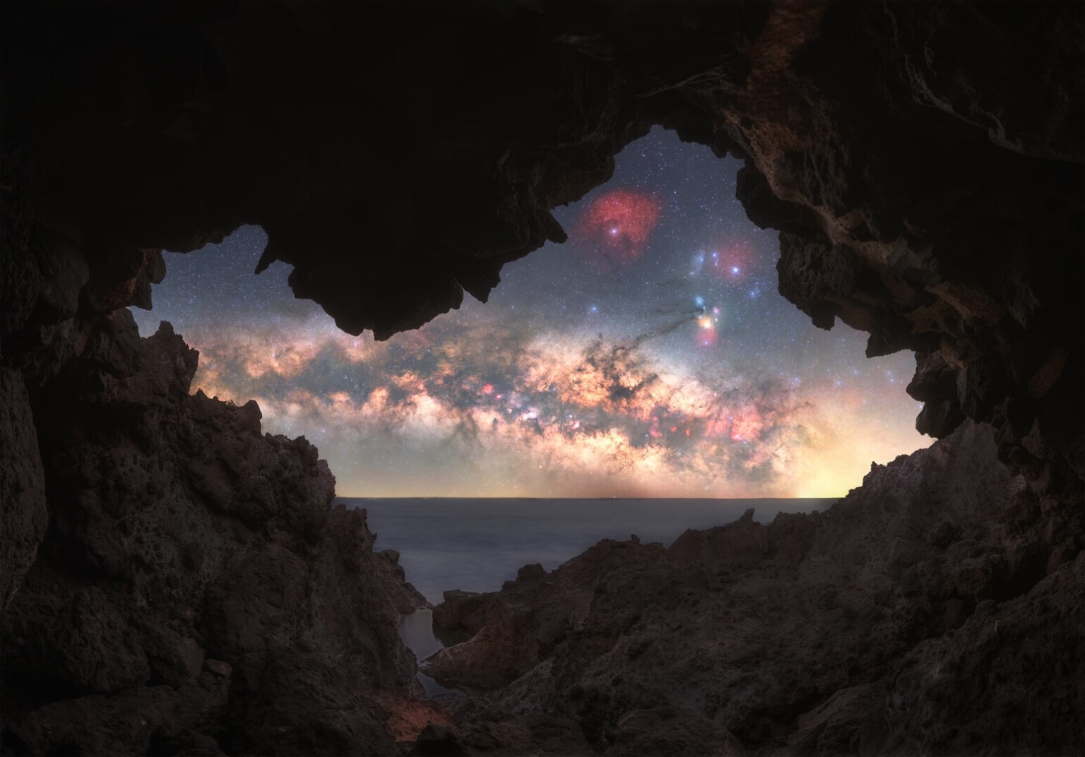 A view of the Milky Way galaxy from inside an opening in a cave.