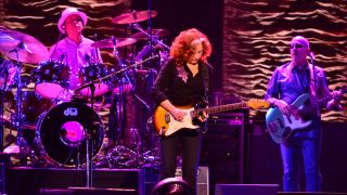 Drummer Ricky Fataar, American blues rock guitarist Bonnie Raitt and bassist James Hutchinson performing live on stage at the Royal Albert Hall in London, on June 27, 2013.