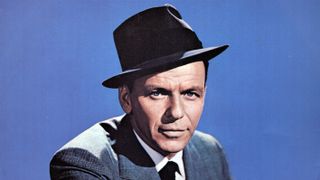 Frank Sinatra in a grey suit and charcoal hat