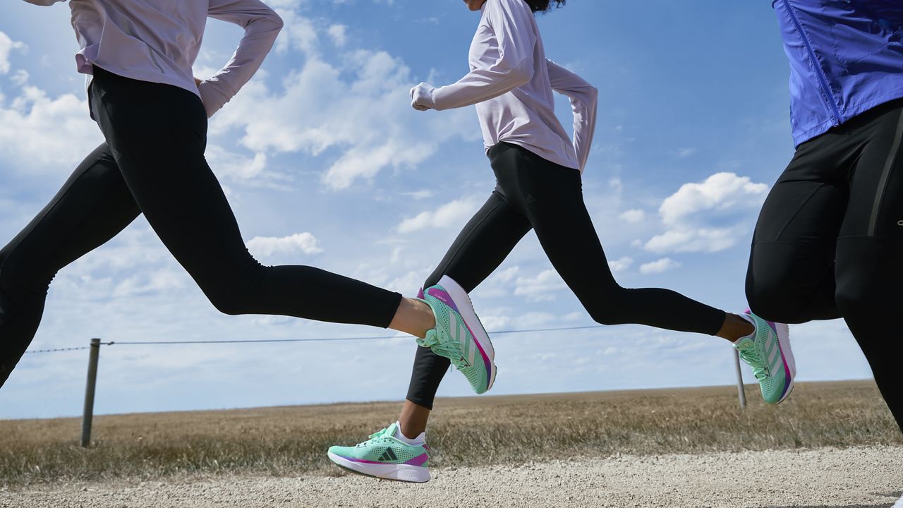 Group of runners on the road wearinf Adidas Adizero SL running shoes