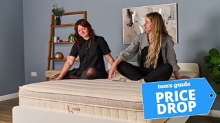 Two Tom's Guide testers sitting on the top of the Birch Luxe Natural smiling, with a Tom's Guide badge overlaid saying 'PRICE DROP'