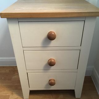 white wooden bedside table with drawers