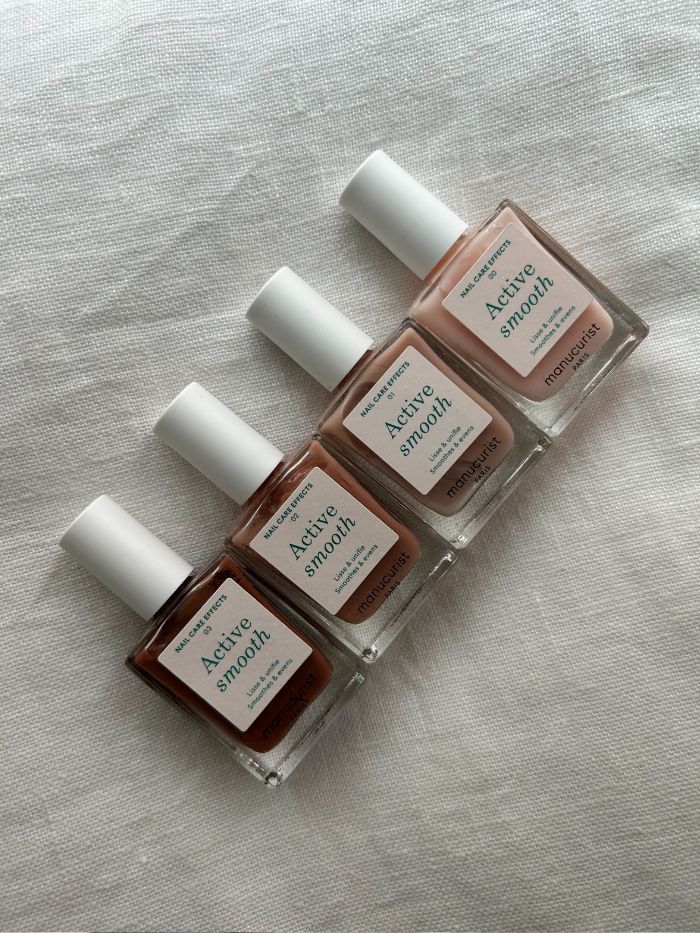 Pictures of the Manucurist Active Smooth nail polish on a white linen background