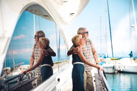 Senior woman and senior man relaxing on the yacht.