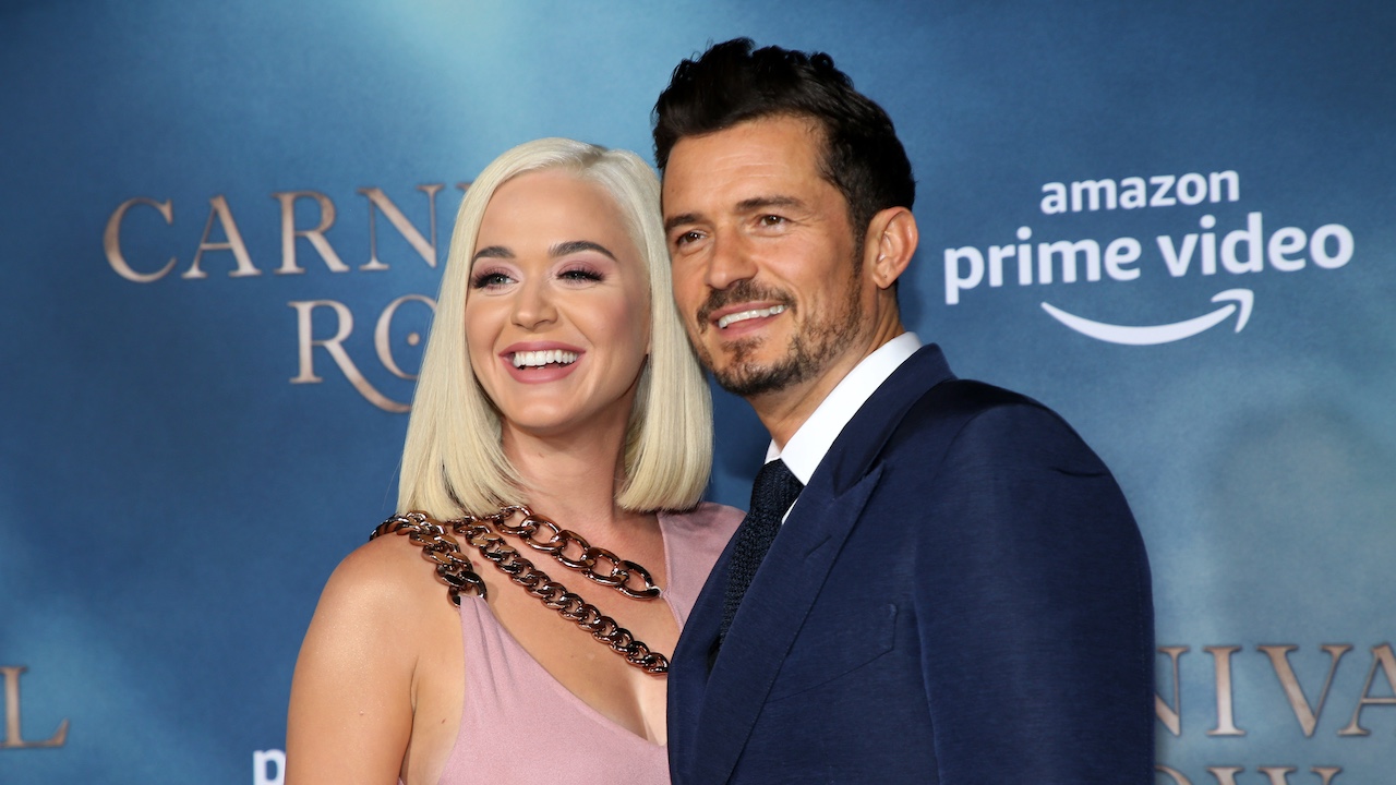 Katy Perry and Orland Bloom smiling on the red carpet for Carnival Row
