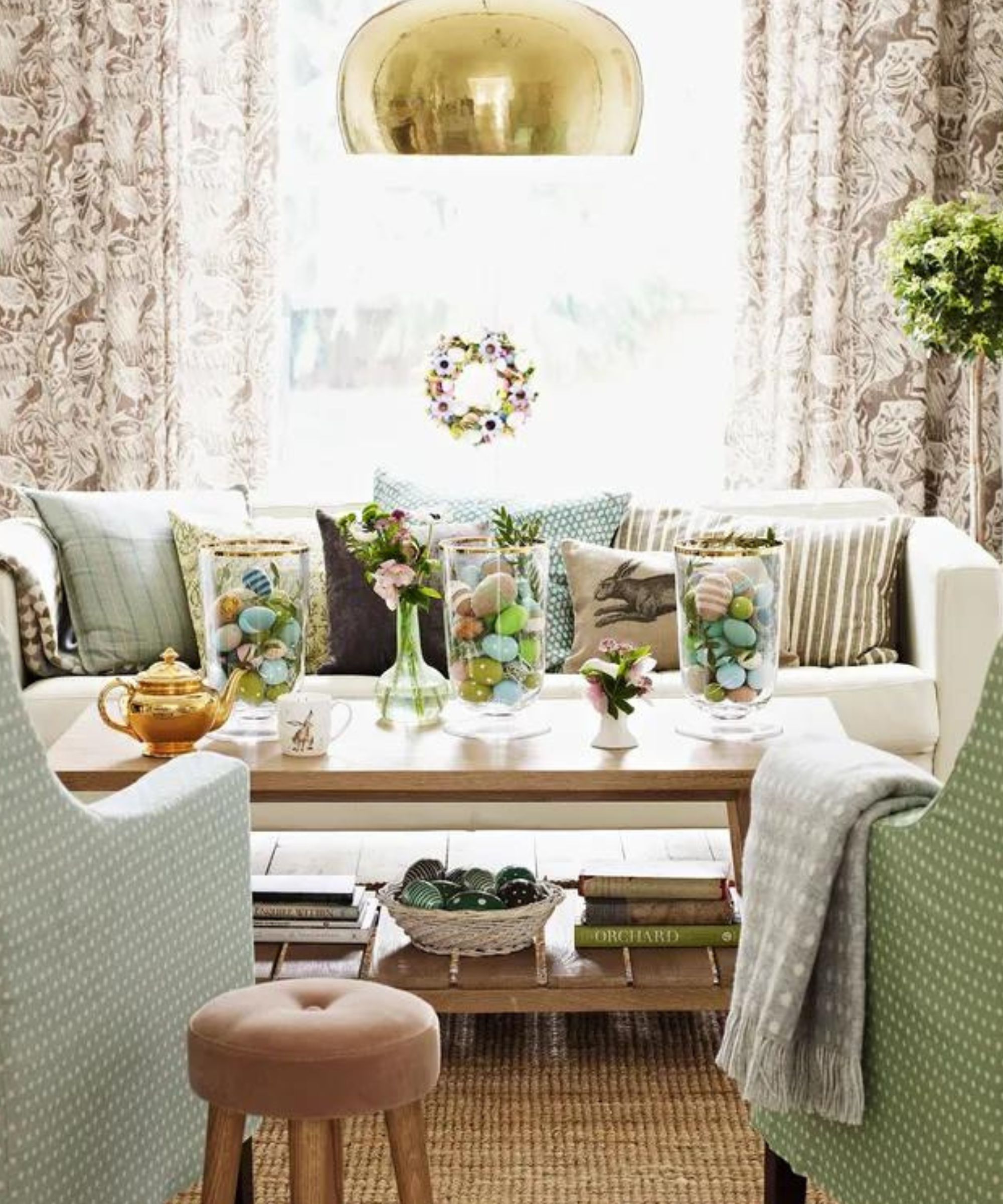 easter themed pastel living room with large glass vases filled with pastel eggs on the coffee table