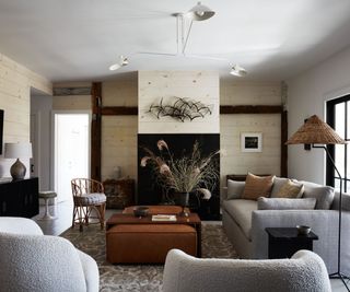 modern cottage living room with gray couches rustic panelled walls and a low ceiling