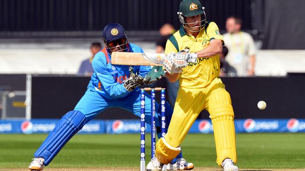 Australia&amp;#039;s Adam Voges (R) plays a shot as India&amp;#039;s captain wicketkeeper Mahendra Singh Dhoni looks on during the warm-up cricket match ahead of the 2013 ICC Champions Trophy between India and