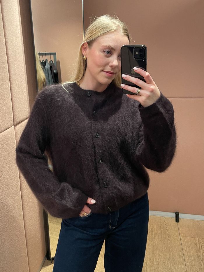 Woman wears brushed cashmere cardigan in brown with blue jeans