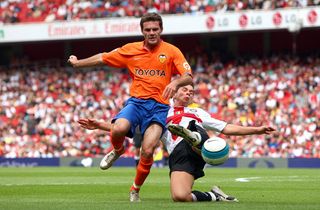 Juan Mata of Valencia is tackled by Ivan Fatic of Inter Milan during the 'Emirates Cup' pre season friendly match between Inter Milan and Valencia at the Emirates Stadium on July 28, 2007 in London, England.