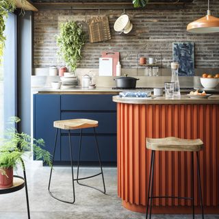 small kitchen with orange ribbed island