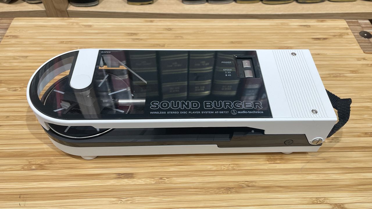 Audio-Technica Sound Burger turntable with no record on a wooden surface
