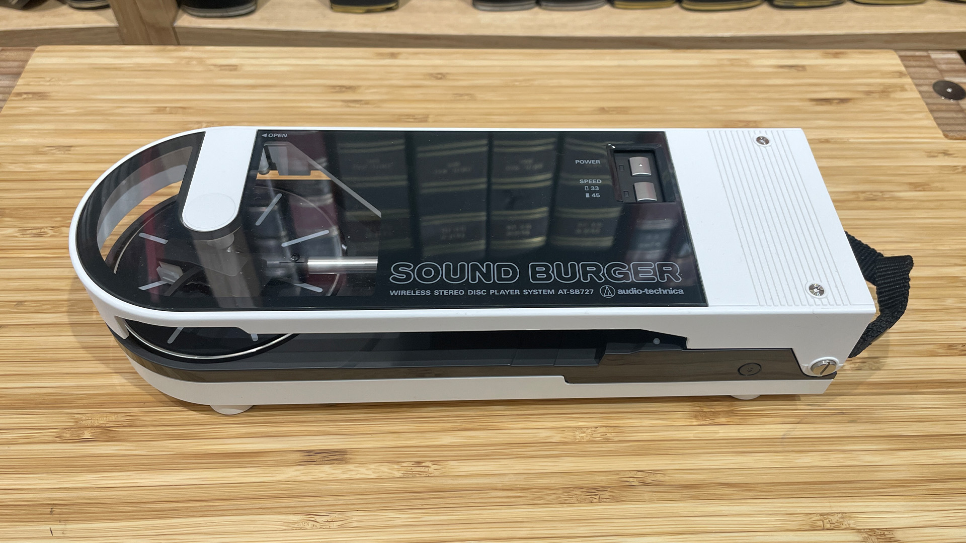 Audio-Technica Sound Burger turntable with no record on a wooden surface